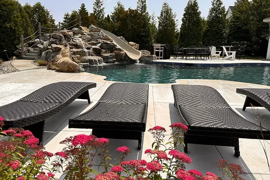 Poolside porcelain paving with lounge chairs
