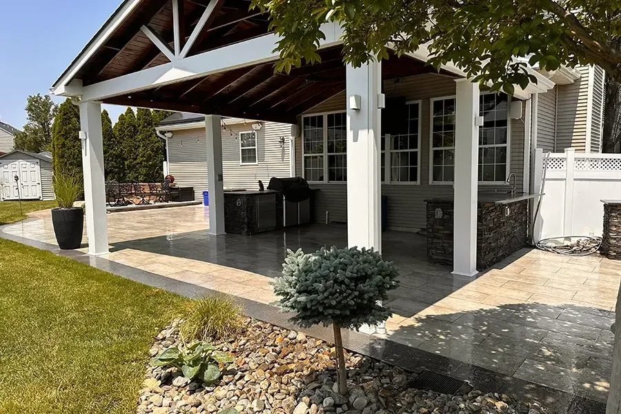 Covered outdoor kitchen beside a home