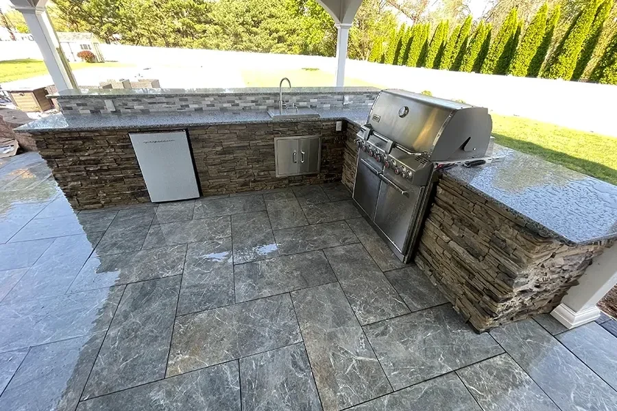 Stone outdoor kitchen with built-in grill